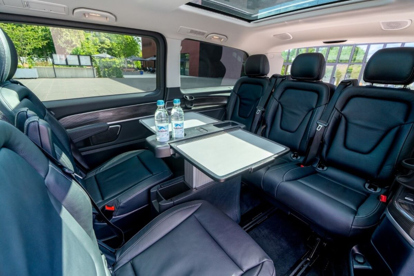 Minivan Mercedes V250d 4matic interior back seats with working table.